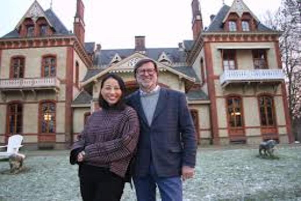 Andreas Hanitsch and Thani Huynh standing together in front of their restored historical property, showcasing their passion for architecture and preservation